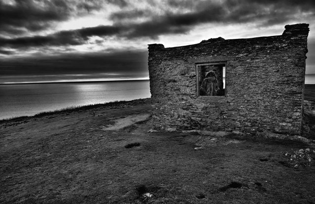 The view on the hill on Burgh Island: a vast, still sea under divine light and hut